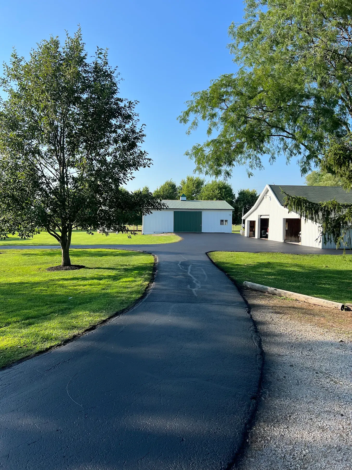 Illustration of sealcoating being applied to a residential driveway, shown with a Hester Asphalt-branded truck